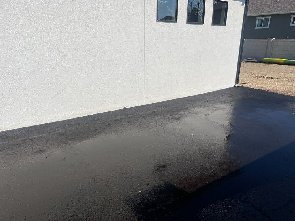 Project Removing Asphalt Residue from a White Stucco Wall image