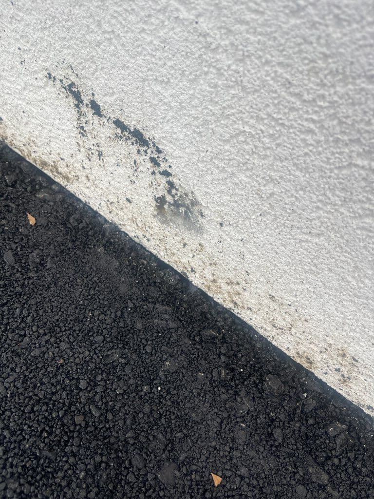 Gallery photos for Removing Asphalt Residue from a White Stucco Wall: Image #1